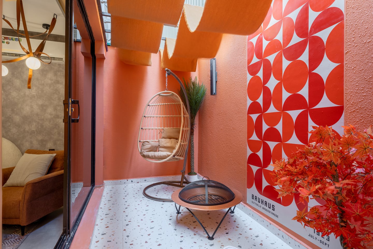 Terracotta patio with a hanging chair at the Art Studio